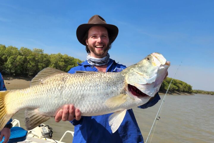 a person holding a fish in the water