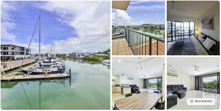 Marina view with boats, balcony, living room, and dining area.